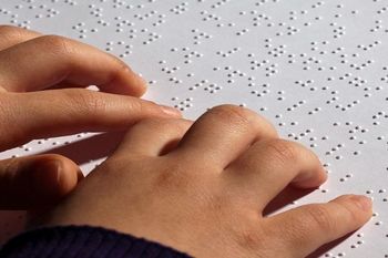 Picture Of Hand Reading Braille